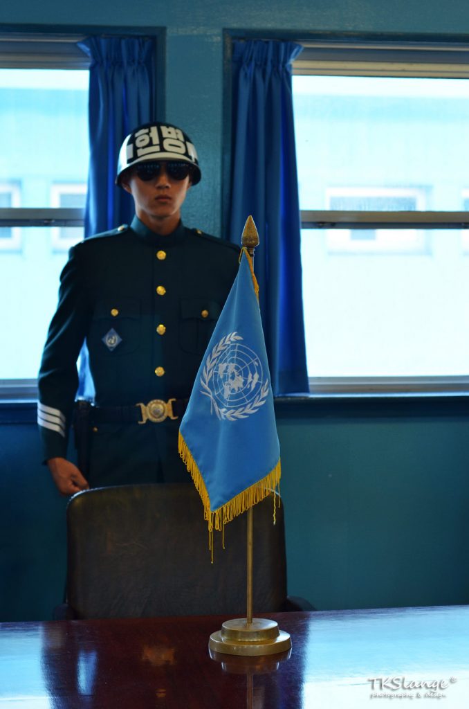ROK soldier in the UNMAC Conference Building. The UN flag is placed in the centre of the table, which marks the MDL. To the left is South Korea, to the right North Korea.