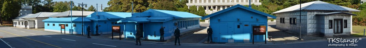 Panoramic picture of the JSA with the blue UN buildings and the North Korean 'visitors centre'.