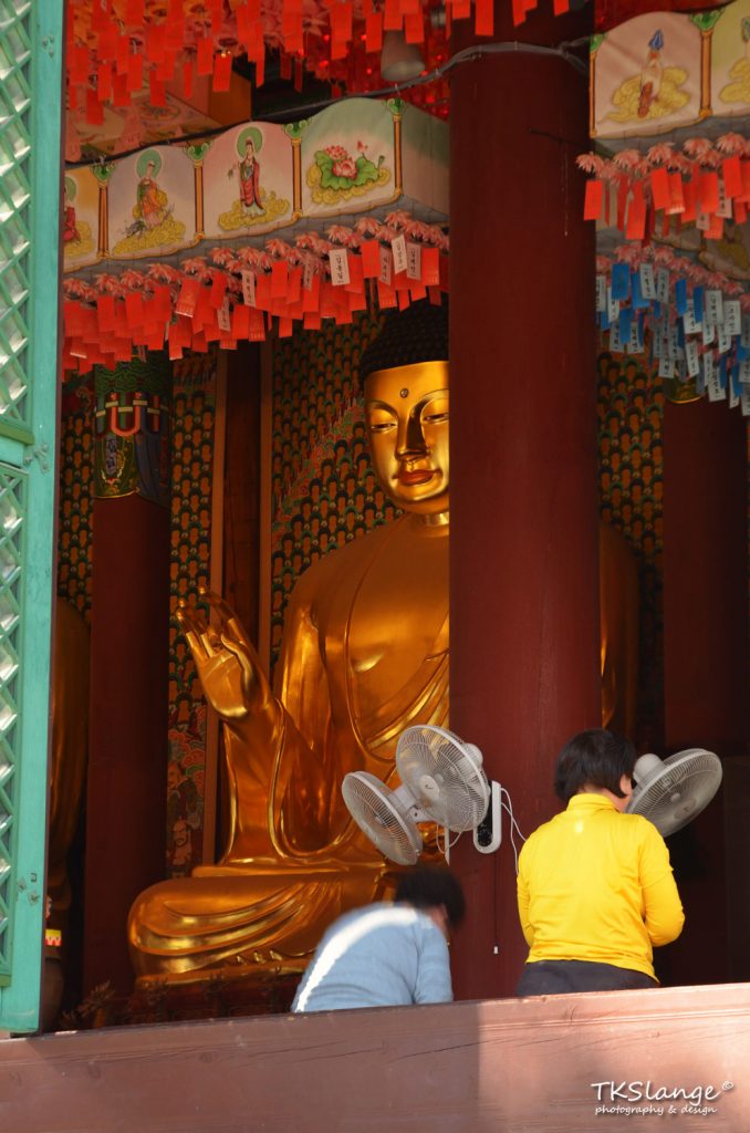 A large golden Buddha sits inside Daeungjeon.